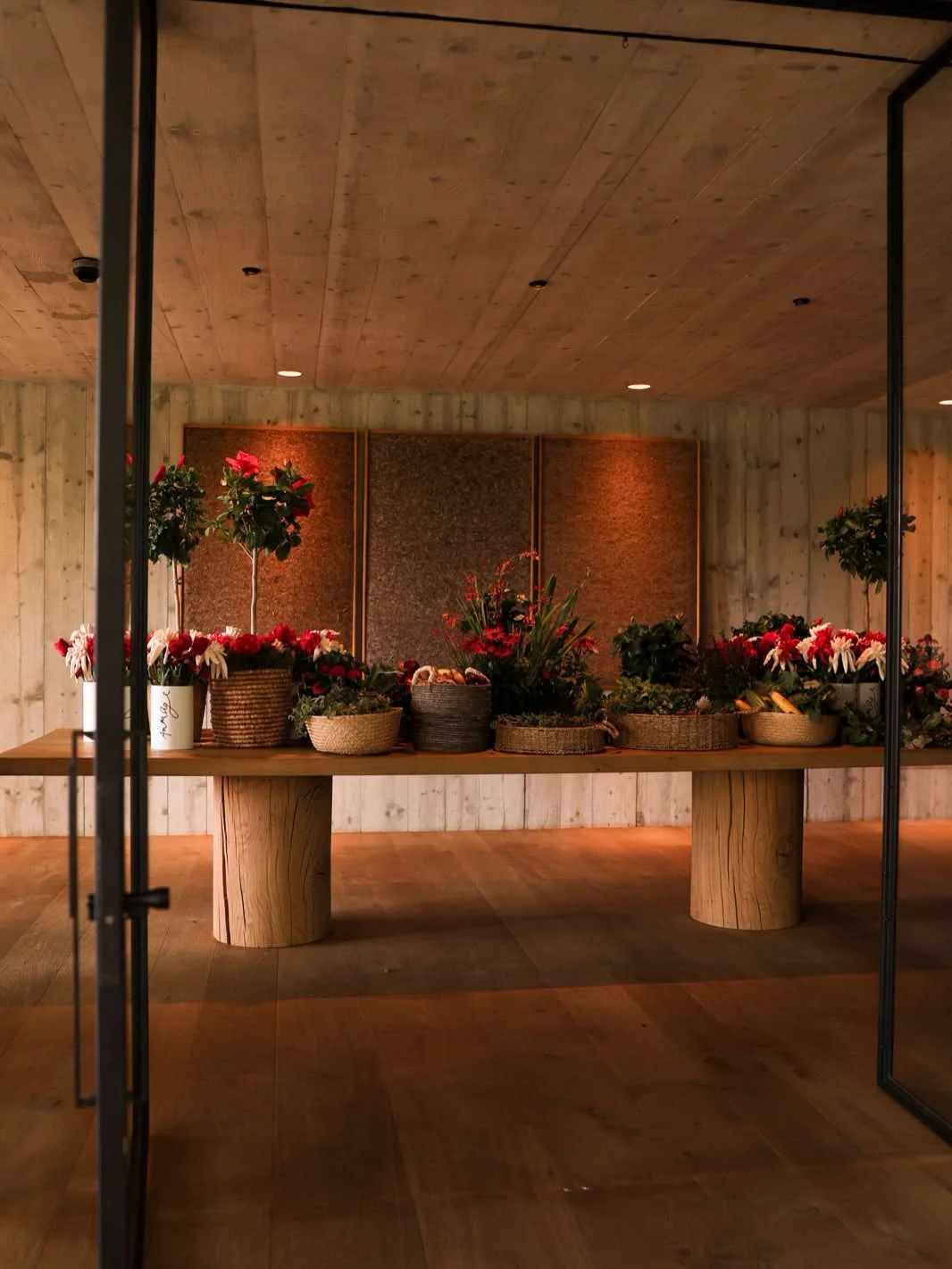 The warmth of an Amouage boutique with flowers and wooden interiors
