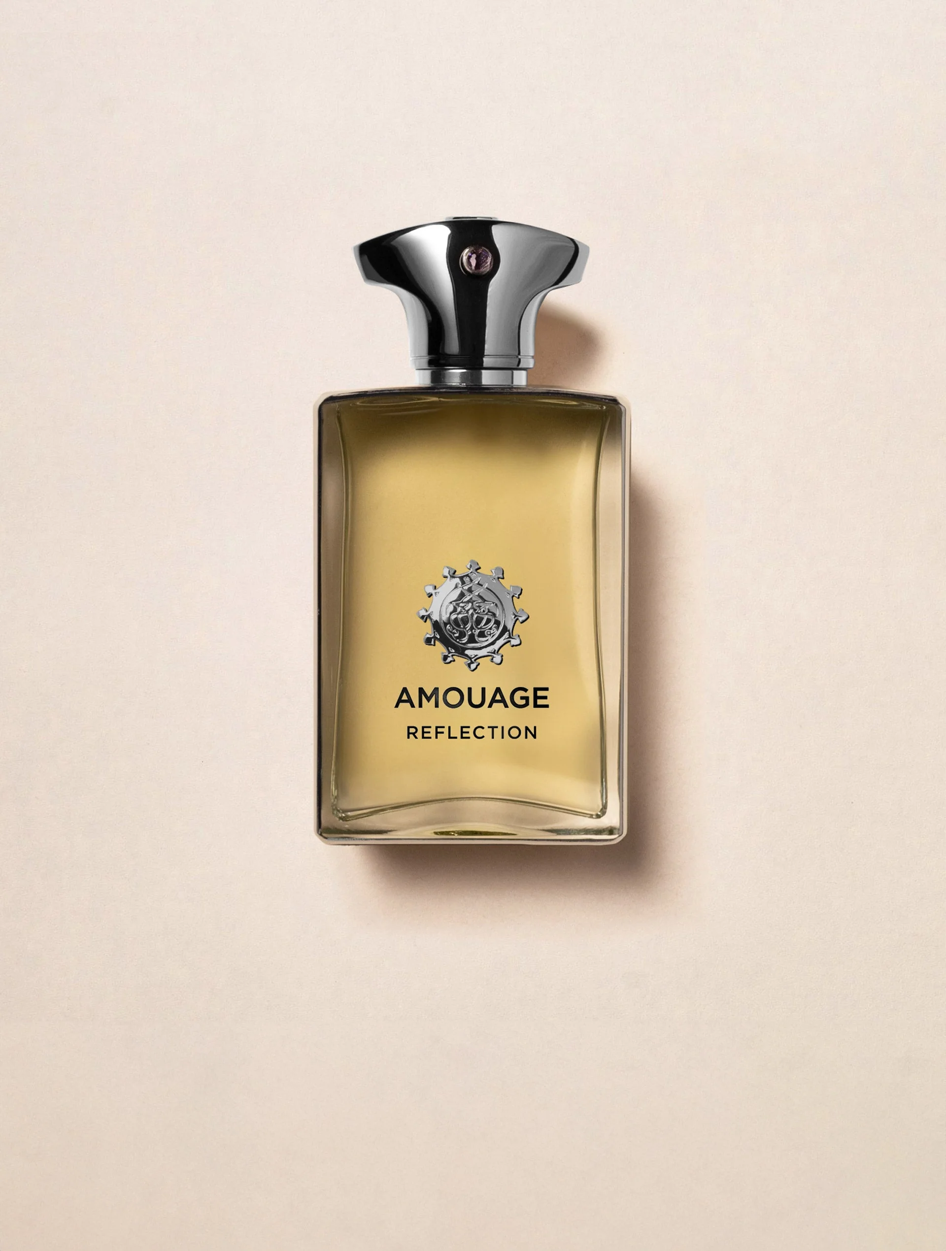 A gold Amouage Reflection perfume bottle