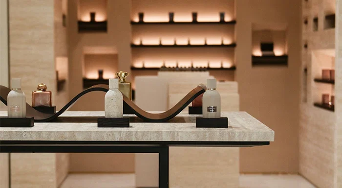 Perfume bottles displayed on a sculptural table