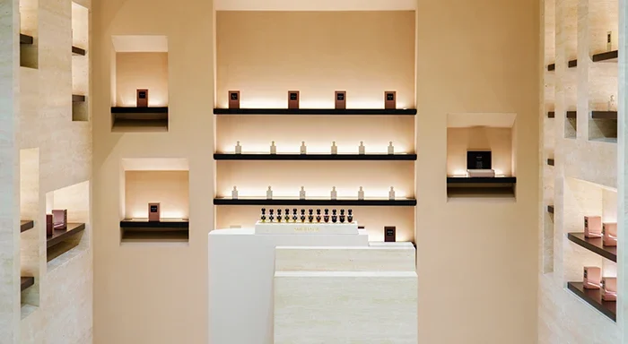Illuminated shelves displaying Amouage perfumes